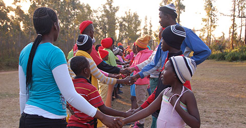 A group of people shaking hands during a programme at Ekukhanyeni