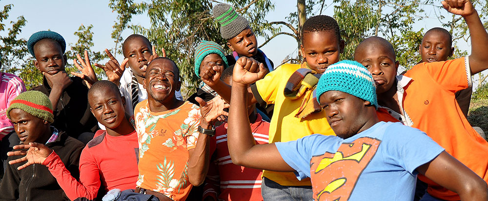 a group of happy youths, dancing and having fun together at Ekukhanyeni