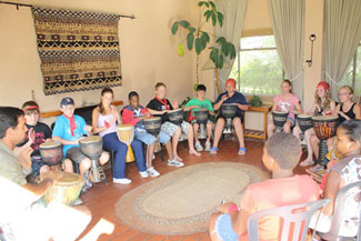 a group of kids participating in the drum circle programme at Ekukhanyeni