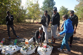 Kids working together on a team building challenge at Ekukhanyeni