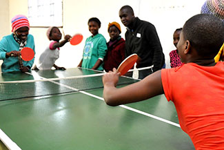 A group of children playing pingpong at Ekukhanyeni