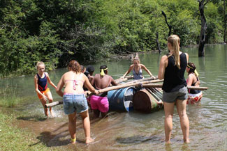 A group of kids playing in the water at Ekukhanyeni